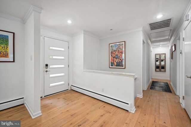 foyer entrance featuring baseboards, a baseboard heating unit, visible vents, and light wood-style floors
