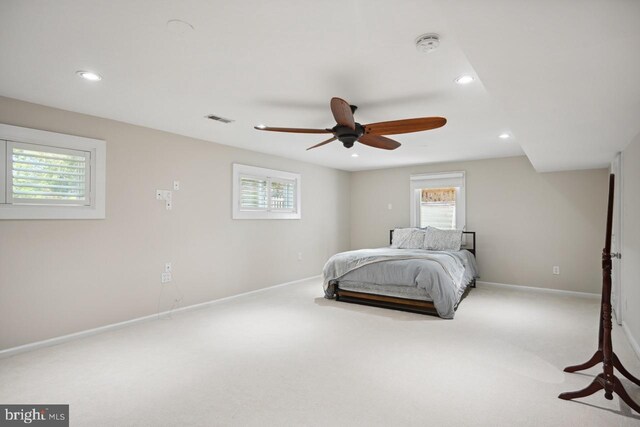 carpeted bedroom with baseboards, multiple windows, and recessed lighting