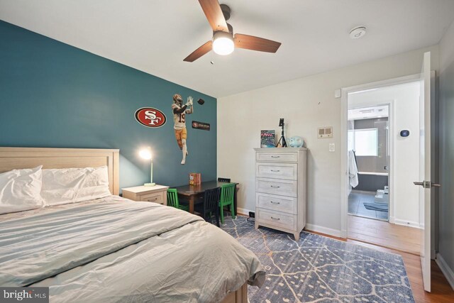 bedroom featuring baseboards, ceiling fan, and wood finished floors