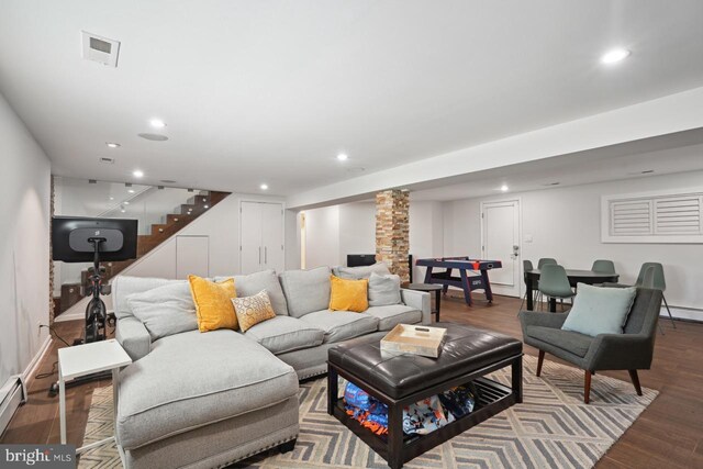 living area featuring recessed lighting, stairs, wood finished floors, and decorative columns