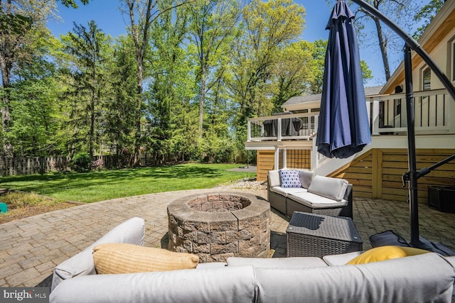 view of patio featuring an outdoor living space with a fire pit, fence, a wooden deck, and stairway