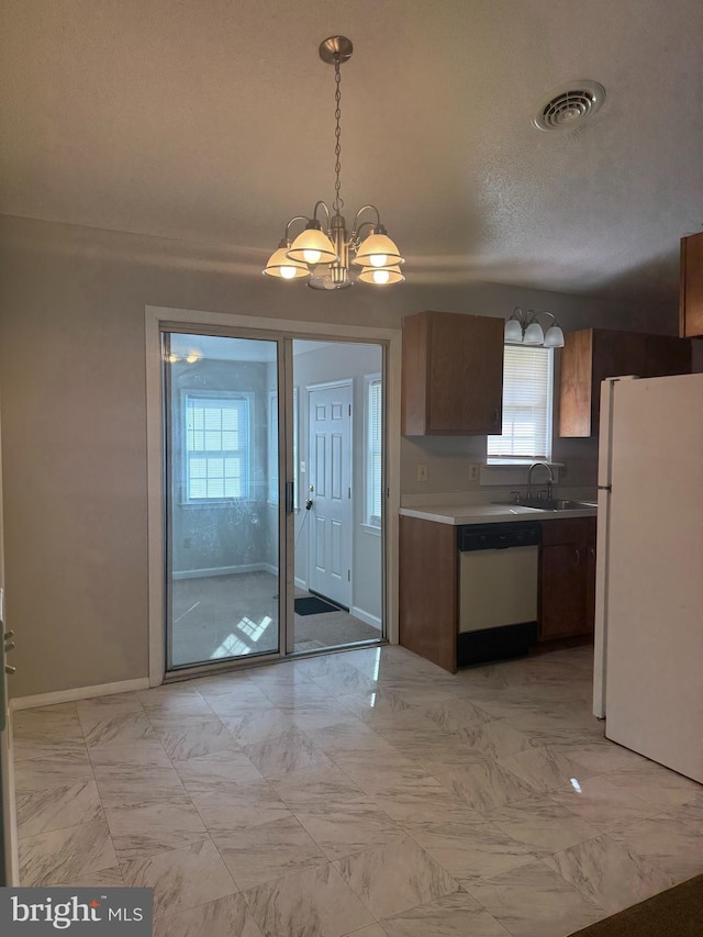 8135 Burnt Branch Dr, Salisbury, MD 21801 - kitchen with dishwashing machine, freestanding refrigerator, a sink, a chandelier, and light marble finish floors