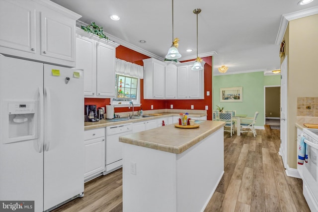 33 Douglas St, Reedville, VA 22539 - kitchen featuring crown molding, light countertops, white cabinetry, and white appliances