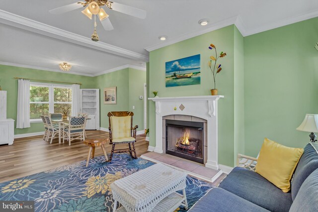 33 Douglas St, Reedville, VA 22539 - living room with wood finished floors, a tiled fireplace, ornamental molding, and baseboards