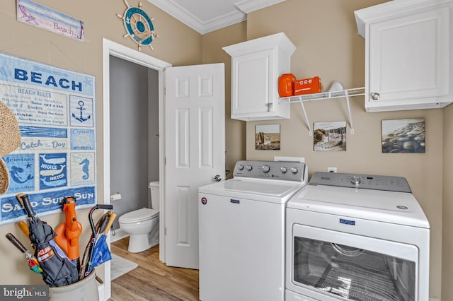 33 Douglas St, Reedville, VA 22539 - washroom featuring washer and dryer, crown molding, cabinet space, and light wood-style floors