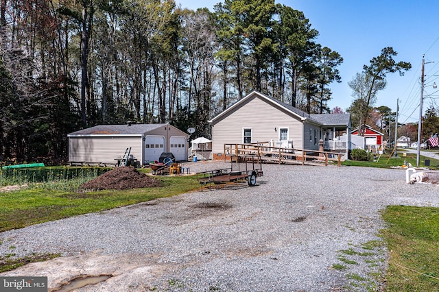 33 Douglas St, Reedville, VA 22539 - exterior space with an outdoor structure, a detached garage, and a wooden deck