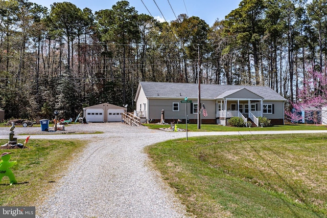 33 Douglas St, Reedville, VA 22539 - single story home featuring driveway, an outbuilding, covered porch, a front lawn, and a garage