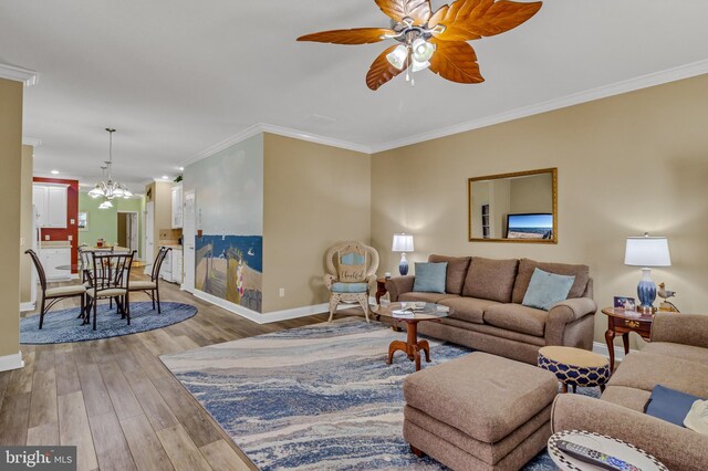 33 Douglas St, Reedville, VA 22539 - living room featuring baseboards, ornamental molding, ceiling fan with notable chandelier, and wood finished floors