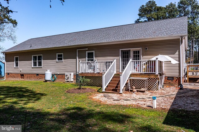 33 Douglas St, Reedville, VA 22539 - back of property featuring roof with shingles, a deck, a yard, and crawl space