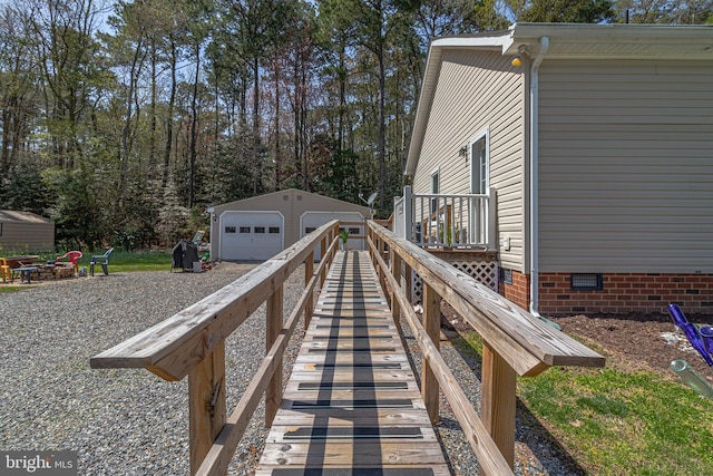 33 Douglas St, Reedville, VA 22539 - wooden deck with a garage and an outbuilding