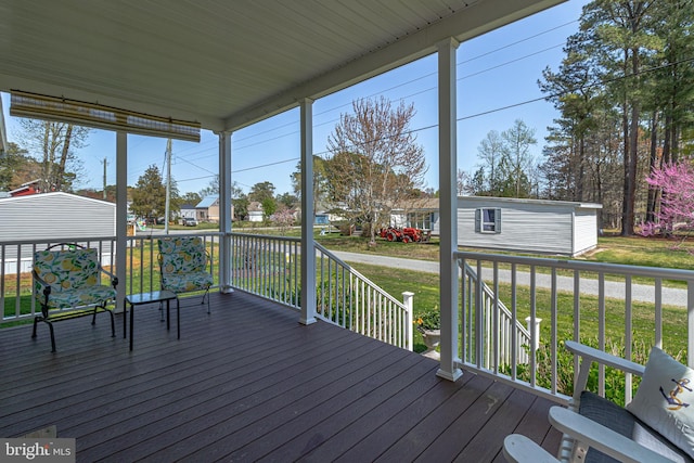 33 Douglas St, Reedville, VA 22539 - wooden deck featuring a lawn and an outdoor structure