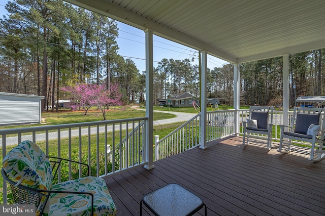 33 Douglas St, Reedville, VA 22539 - wooden terrace featuring an outdoor structure, covered porch, and a yard