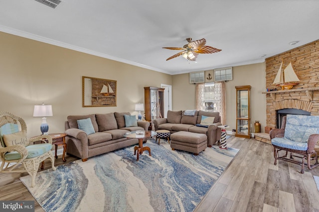 33 Douglas St, Reedville, VA 22539 - living room with a fireplace, a ceiling fan, visible vents, ornamental molding, and wood finished floors