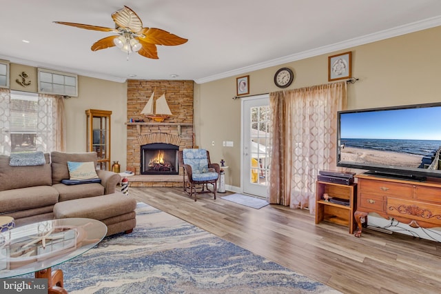 33 Douglas St, Reedville, VA 22539 - living area featuring wood finished floors, a large fireplace, ornamental molding, baseboards, and a ceiling fan