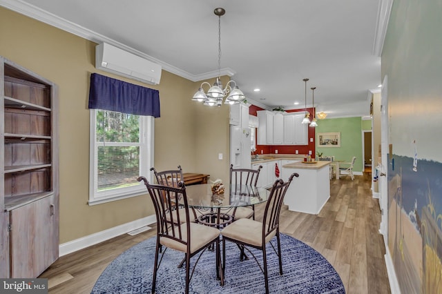 33 Douglas St, Reedville, VA 22539 - dining room featuring light wood-style flooring, baseboards, ornamental molding, a wall mounted air conditioner, and a notable chandelier