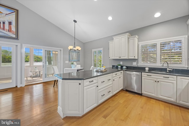 kitchen featuring a sink, a notable chandelier, a peninsula, white cabinetry, and stainless steel dishwasher
