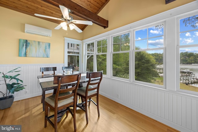 sunroom featuring a wall unit AC, lofted ceiling with beams, wood ceiling, wainscoting, and wood finished floors