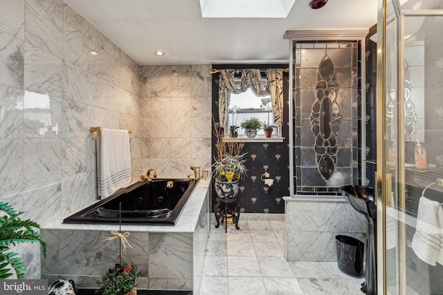 2217 Locust St, Philadelphia, PA 19103 - bathroom featuring recessed lighting, a sink, marble finish floor, a garden tub, and a skylight