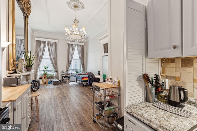 2217 Locust St, Philadelphia, PA 19103 - interior space featuring a chandelier, crown molding, pendant lighting, wooden counters, and wood finished floors
