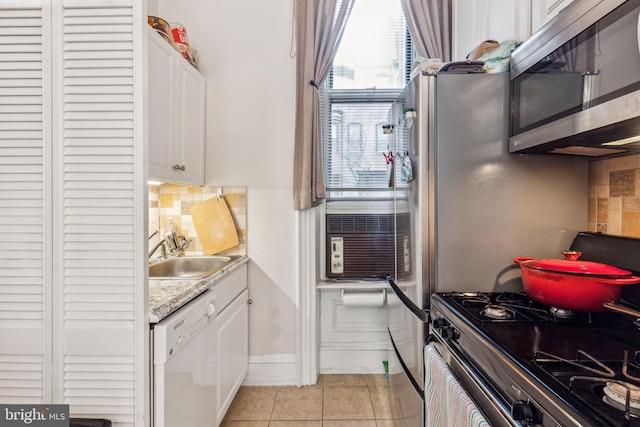 2217 Locust St, Philadelphia, PA 19103 - kitchen featuring stainless steel microwave, dishwasher, a sink, white cabinetry, and range with gas stovetop