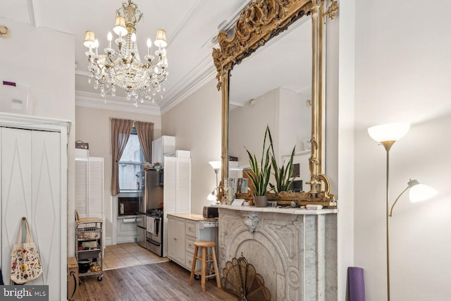 2217 Locust St, Philadelphia, PA 19103 - entryway featuring light wood-type flooring, ornamental molding, and a notable chandelier