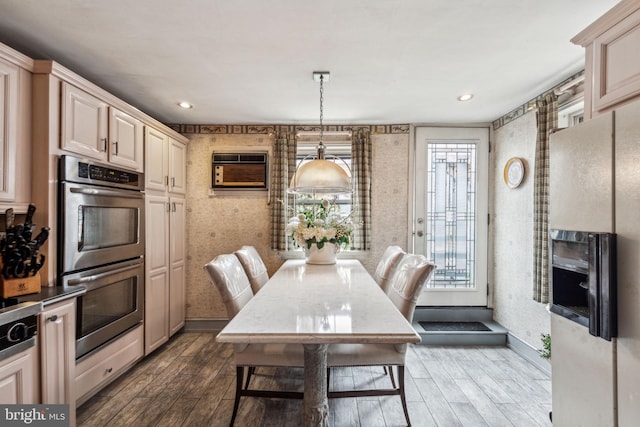2217 Locust St, Philadelphia, PA 19103 - dining area featuring wallpapered walls, an AC wall unit, dark wood finished floors, and baseboards