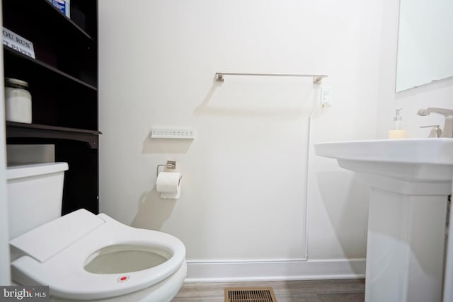 43 Pratt, Lawrence Township, NJ 08648 - half bath featuring wood finished floors, visible vents, toilet, and baseboards