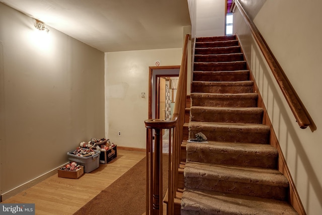 121 E Lafayette Ave, Magnolia, NJ 08049 - staircase featuring carpet flooring, wood finished floors, and baseboards