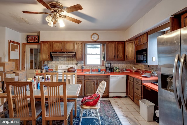 121 E Lafayette Ave, Magnolia, NJ 08049 - kitchen featuring white appliances, a sink, under cabinet range hood, ceiling fan, and backsplash