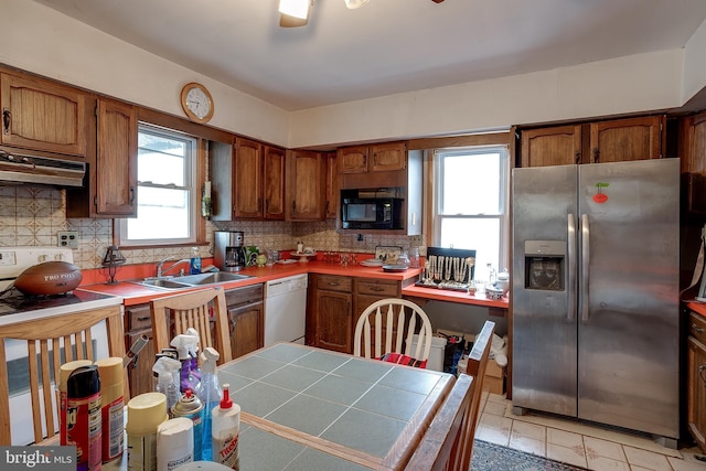 121 E Lafayette Ave, Magnolia, NJ 08049 - kitchen with stainless steel fridge with ice dispenser, under cabinet range hood, white dishwasher, black microwave, and brown cabinets