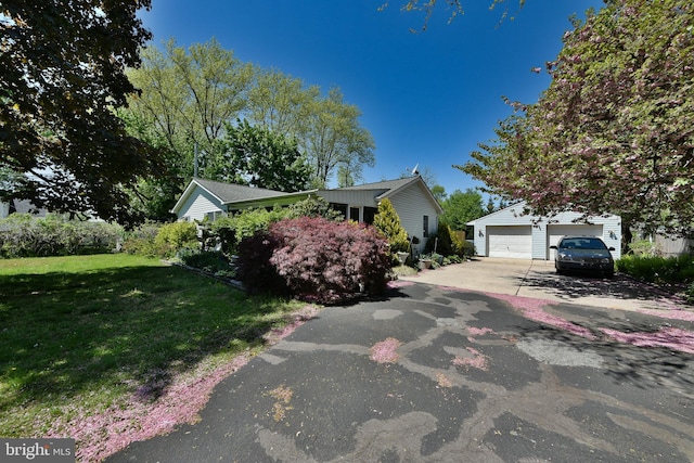 3703 Spruce St, Bristol, PA 19007 - view of front facade featuring a garage, an outbuilding, and a front yard