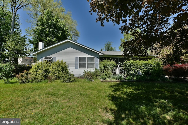 3703 Spruce St, Bristol, PA 19007 - view of home's exterior with a lawn and a chimney