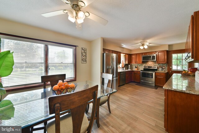 3703 Spruce St, Bristol, PA 19007 - dining space with light wood-type flooring, a textured ceiling, and ceiling fan