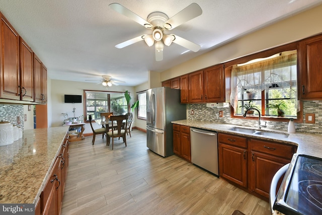 3703 Spruce St, Bristol, PA 19007 - kitchen featuring a ceiling fan, a sink, appliances with stainless steel finishes, and backsplash