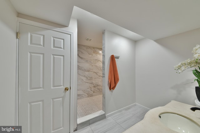 3703 Spruce St, Bristol, PA 19007 - full bath featuring baseboards, a sink, tiled shower, and tile patterned flooring