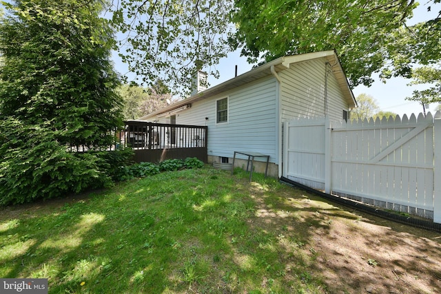 3703 Spruce St, Bristol, PA 19007 - view of property exterior featuring a lawn, fence, a wooden deck, and a chimney