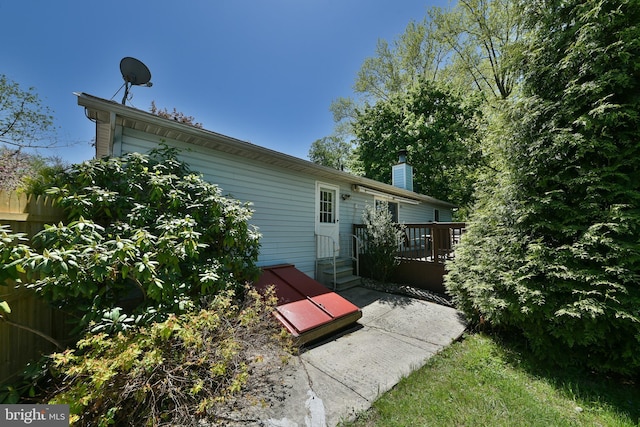 3703 Spruce St, Bristol, PA 19007 - back of property with a deck, fence, and a chimney
