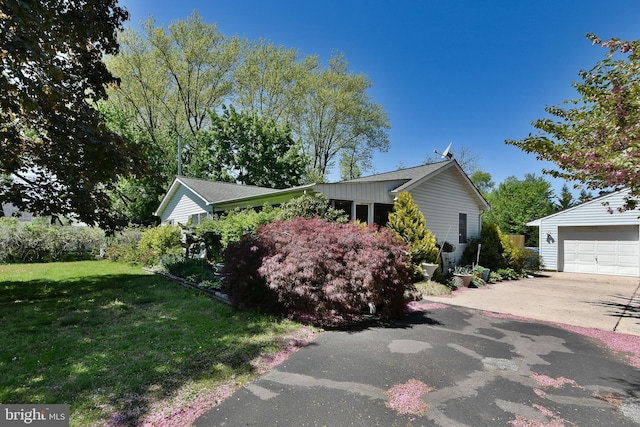 3703 Spruce St, Bristol, PA 19007 - view of side of property featuring a garage, an outdoor structure, concrete driveway, and a yard