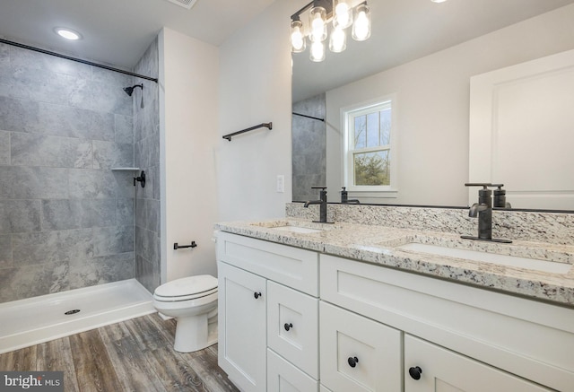 5 Cornwallis Cv, Ruther Glen, VA 22546 - bathroom with double vanity, wood finished floors, toilet, and a sink