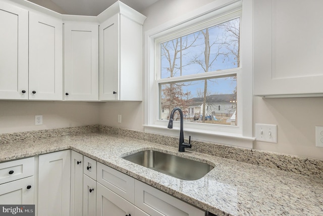5 Cornwallis Cv, Ruther Glen, VA 22546 - kitchen with white cabinets, light stone countertops, and a sink