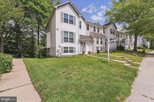 view of property with a front lawn and a residential view