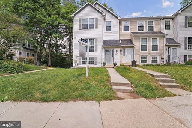 view of property featuring a front lawn