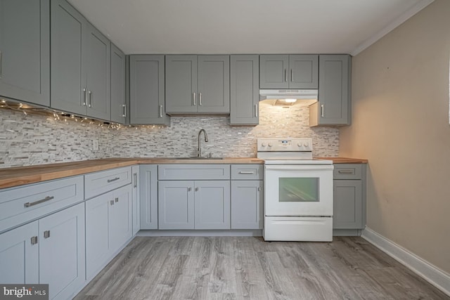 kitchen featuring white range with electric cooktop, wooden counters, a sink, and under cabinet range hood