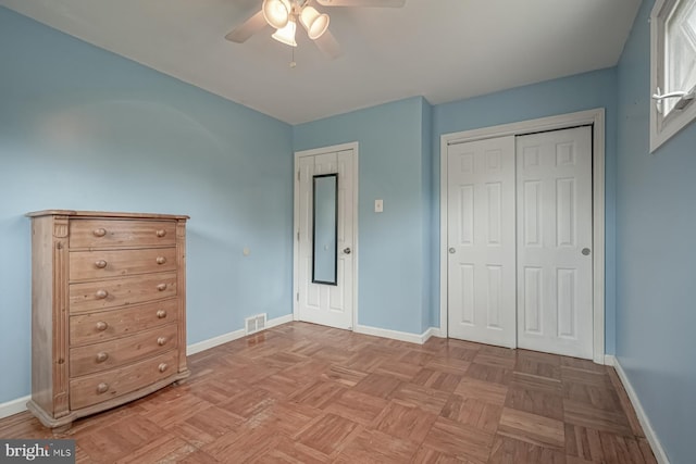 unfurnished bedroom with baseboards, a closet, and a ceiling fan