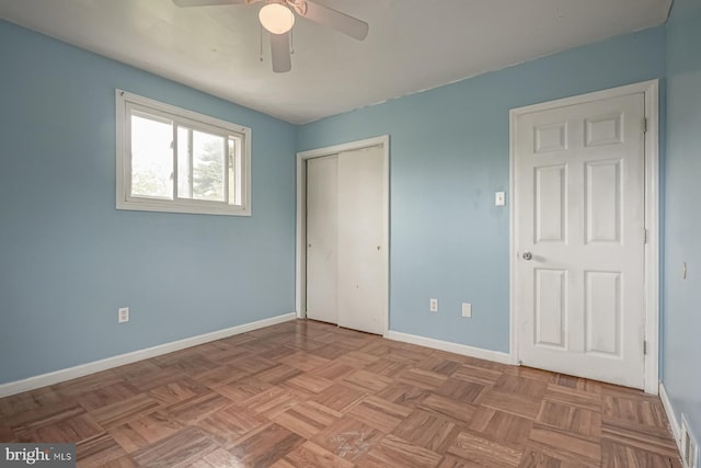 unfurnished bedroom with baseboards, a closet, and ceiling fan