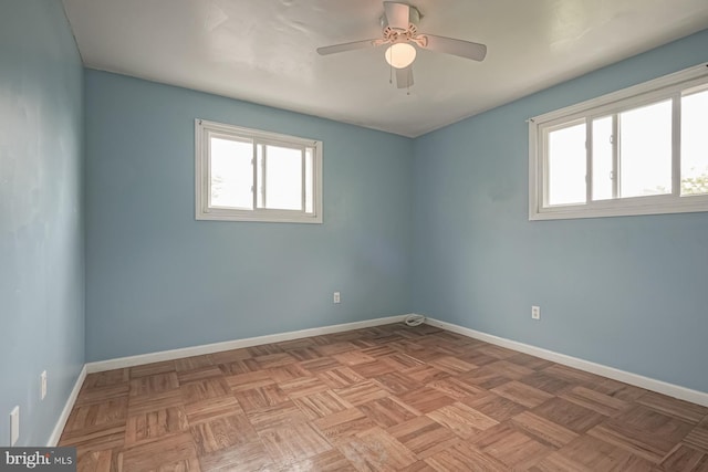 unfurnished room featuring baseboards and a ceiling fan