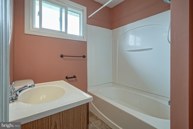 full bath with a sink, tile patterned floors, and shower / washtub combination