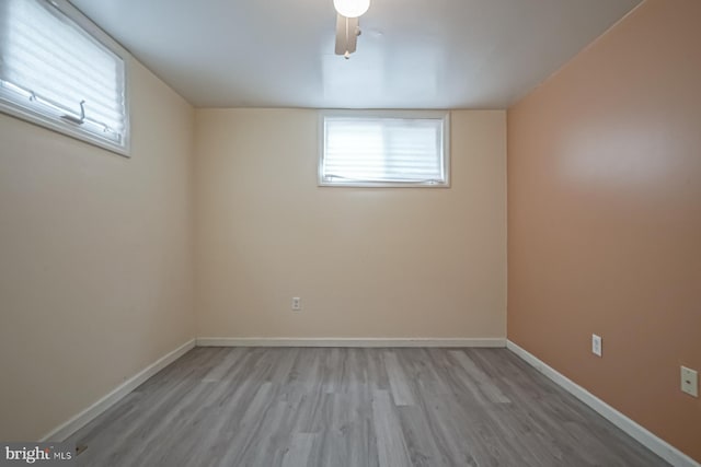 basement featuring wood finished floors and baseboards