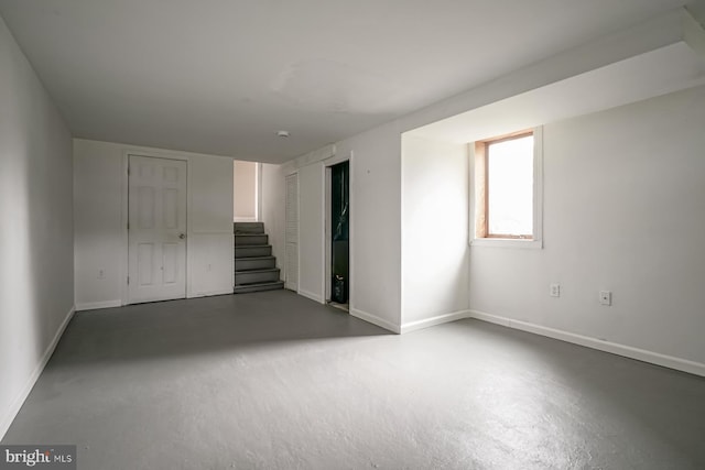 unfurnished bedroom featuring baseboards and concrete floors