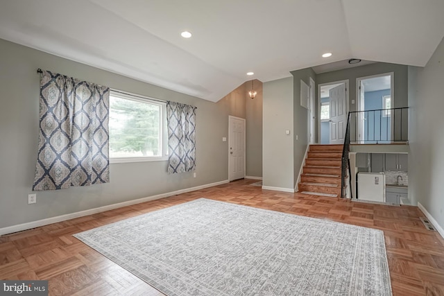 unfurnished living room with lofted ceiling, stairway, baseboards, and recessed lighting